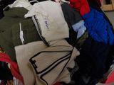 a pile of clothes that is sitting in a suitcase