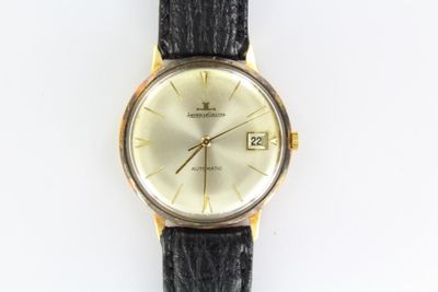 a watch that is sitting on a white surface