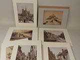 four black and white photographs of a street with buildings and a bridge