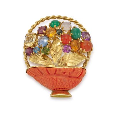 a red bowl with a bunch of flowers inside of it
