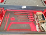a red tool box with tools in it on a table