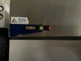 a close up of a stainless steel refrigerator with a sticker on it