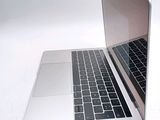 two laptops sitting side by side on a white surface