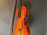 an old violin with a bow and a bow rest on a table