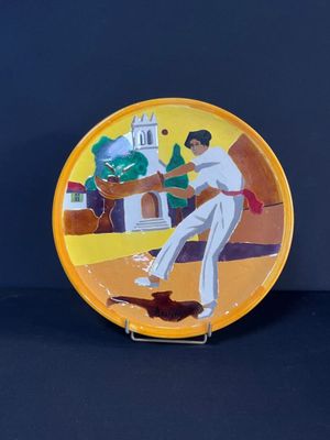 une assiette sur laquelle est représenté un homme jouant au baseball