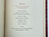 a menu in a book on a white table
