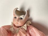 a doll that is wearing a helmet on it ' s head