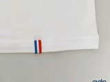 a white t - shirt with a red, white, and blue stripe on it