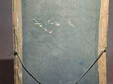 painting on a wooden easel with a chalk board attached to it
