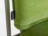 a close up of a green chair with a black label on it
