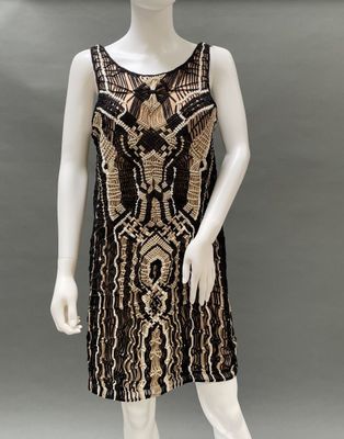 a mannequin wearing a black and gold dress on a mannequin