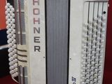 a white accordion that is sitting on a red table