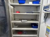 many shelves in a small room with blue bins on them