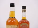 two bottles of whiskey sitting next to each other on a table