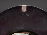 a close up of a clock that is on a table