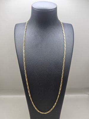a gold chain necklace on a mannequin display