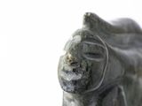 a statue of a frog that is sitting on a table