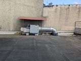 a large building with a roof and a pipe on top of it