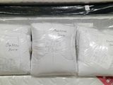 four pillows in a plastic bag on top of each other