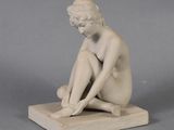 statue of a woman sitting on a marble base