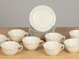 a lot of cups and saucers on the table