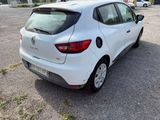 the back of a white car parked in a parking lot