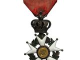 une image représentant une médaille ornée d'un ruban rouge et d'une étoile
