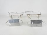 three silver metal trays with handles and handles on a white surface