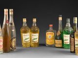 several bottles of alcohol are lined up in a row on a gray surface