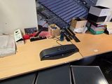 a desk with a keyboard, mouse, and other items on it