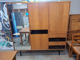 an image of a wooden cabinet with a mirror on it