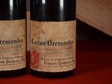 two bottles of wine sitting next to each other on a table