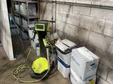 a machine that is sitting next to a pile of boxes