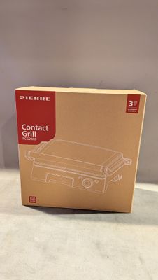 la boîte est ouverte pour montrer le contenu d'un barbecue compact