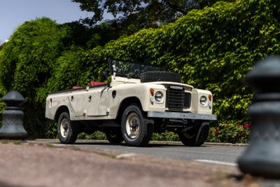 a white land rover parked on the side of the road