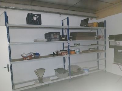 a room with a lot of shelves and a chalk board