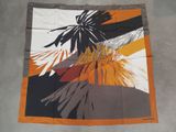 a close up of a square scarf with a bird on it