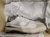 a box with a pair of white sneakers inside of it