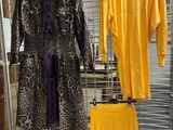 two coats hanging on a wire rack in a store