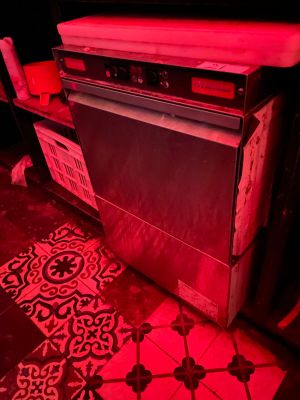 an image of a kitchen with a red light in the dark