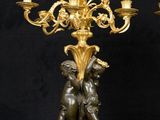 pair of antique bronze candelabs with figurines on stands