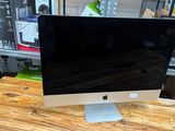 a computer monitor sitting on top of a wooden desk