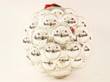 a glass ornament with a red ribbon on top of it