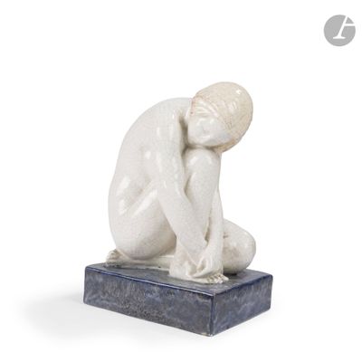statue of a man sitting on a marble base with his head in his hands