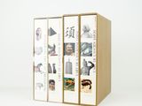 two cardboard boxes with pictures of different people on them on a white surface