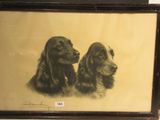 tableau représentant deux chiens, encadré et accroché au mur