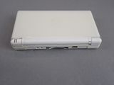 a white laptop sitting on a table with its lid open