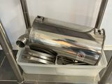 a metal shelf with a bunch of utensils on it
