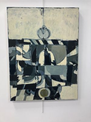 un tableau accroché au mur, sur lequel figure une horloge