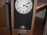 a clock that is sitting on the floor next to a table